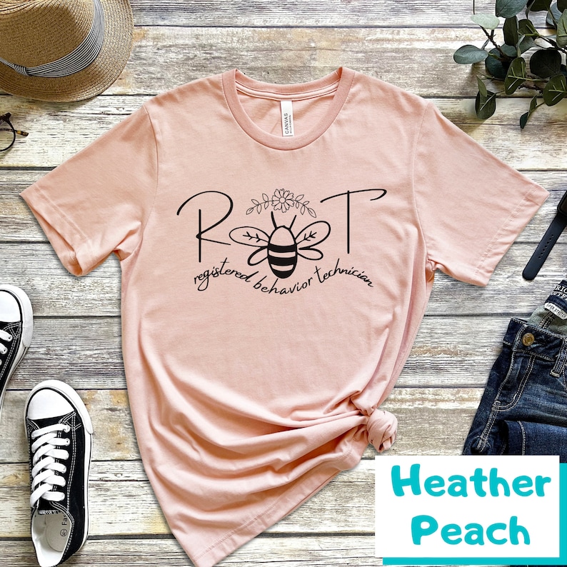 May include: A pink t-shirt with a black bee graphic and the text "RBT registered behavior technician".