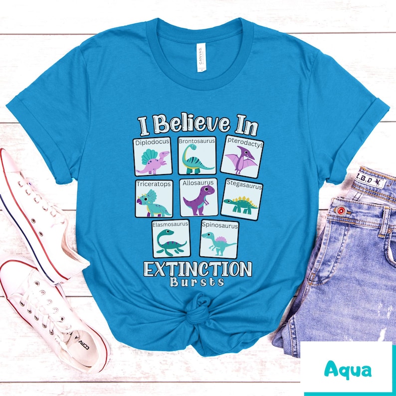 May include: A turquoise blue t-shirt with a graphic of dinosaurs and the text "I Believe In Extinction Bursts".
