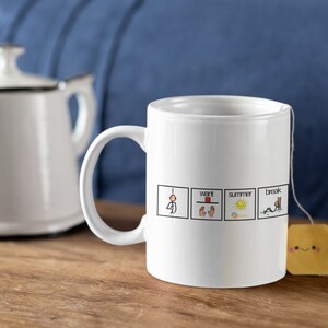 May include: White ceramic mug with a black outline and a handle. The mug has four squares with stick figures and text that reads "I want summer break".