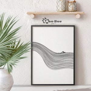 May include: Black and white line art print of a person swimming in a wave. The print is framed in a black frame and is hanging on a white wall.