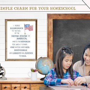 May include: A framed print with the Pledge of Allegiance text and an American flag illustration. A globe, a microscope, and a white pitcher with pencils are on a wooden shelf. A mother and daughter are sitting at a table, working on a craft project.