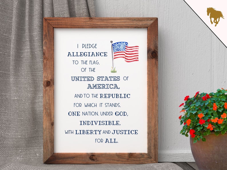 May include: A framed print with the Pledge of Allegiance to the United States of America. The print features a watercolor illustration of the American flag.