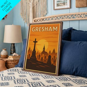 May include: A rectangular wall art print in a dark walnut floater frame featuring a stylized orange and brown sunset landscape of a cemetery with a prominent cross, gravestones, and a church silhouette under the text GRESHAM in bold letters.