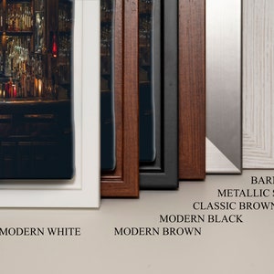 May include: A close-up of six different picture frames, each with a different color and style. The frames are arranged from left to right, with the modern white frame on the left and the barnwood frame on the right. The frames are all made of wood and have a variety of finishes, including white, brown, black, and silver. The frames are all in focus and the image is well-lit.