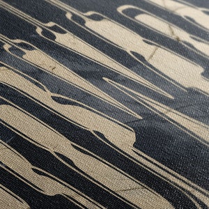 May include: Close-up of a textured canvas with a black and white abstract design. The design features vertical lines and curves, creating a dynamic and modern look.