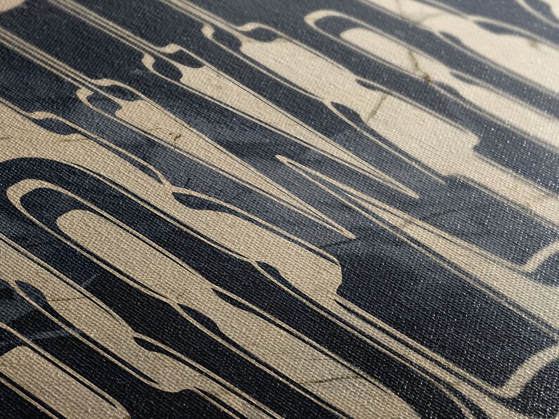 May include: Close-up of a textured canvas with a black and white abstract design. The design features vertical lines and curves, creating a dynamic and modern look.