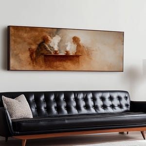 May include: A framed artwork depicts two figures seated at a table, enjoying a warm beverage. The painting is in sepia tones, with steam rising from the cups. The artwork hangs above a black leather sofa.