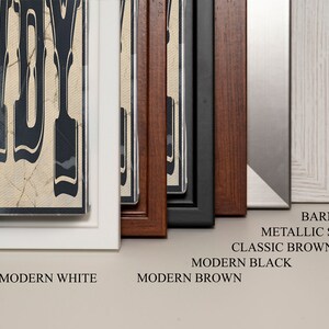 May include: A close-up of different frame options for a print. The frames are in the following colors: modern white, modern brown, modern black, classic brown, metallic silver, and barnwood.
