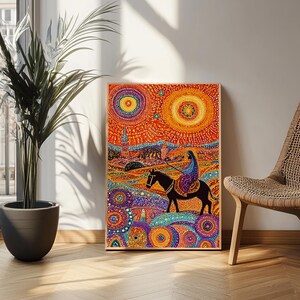 May include: A framed art print featuring a vibrant, colorful illustration. The artwork depicts a person riding a horse, set against a backdrop of a city and two sun-like circles. The color palette includes orange, blue, and purple.