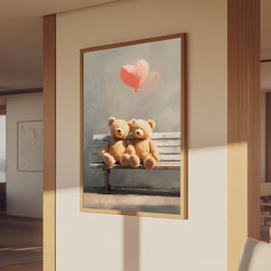 May include: A framed artwork depicts two teddy bears sitting on a bench beneath a pink heart-shaped balloon. The bears are light brown with dark brown accents. The background is a soft, muted gray with subtle color splashes.