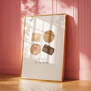 May include: A gold-framed print displaying illustrations of four biscuits: a square, a round, a heart-shaped, and a rectangular one. The text at the bottom says, "This and a big cup of tea."