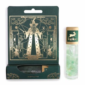 Könnte beinhalten: Ein grünes und goldenes Box-Set mit einer Glasflasche. Die Box zeigt eine Zauberer-Illustration und den Text "diffuses negative emotions". Die Flasche hat einen Holzdeckel mit einem Kaninchen-Logo und ist mit grünen Kristallen gefüllt. Das Set ist mit "Aventurine" beschriftet.