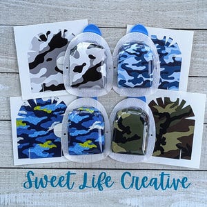 May include: Six different camouflage patterns for a medical device. The patterns include black and white, blue and white, blue and green, green and brown, and two variations of blue and green. The patterns are printed on clear adhesive sheets.