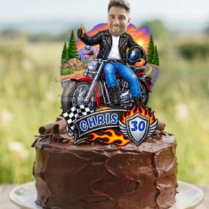 May include: A chocolate frosted cake topped with a custom acrylic topper featuring a cartoon illustration of a person on a red motorcycle, wearing a black leather jacket and blue jeans. The topper includes the text CHRIS and the number 30.