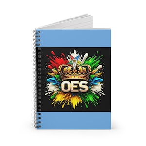 May include: A spiral notebook with a blue cover featuring a colorful design of paint splatters and a gold crown with the letters "OES" in the center.