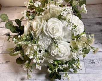 Bridal and bridesmaid bouquet - classic romance, minimalist style with white roses encased in gorgeous eucalyptus and other greenery.