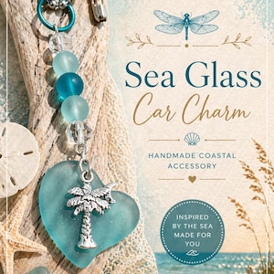 May include: A sea glass car charm with a heart-shaped pendant featuring a silver palm tree. The charm includes blue and clear beads, and the text "Sea Glass Car Charm" is displayed. A handmade coastal accessory.