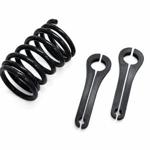 May include: A black coil spring and two black spring compressor tools are displayed against a white background. The spring is tightly wound, and the tools have a unique shape with a circular top and a split end.