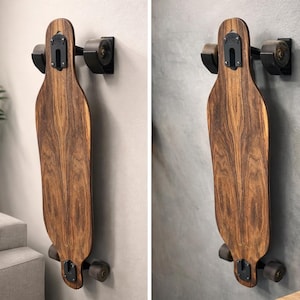 May include: A longboard made of dark wood, mounted on a wall with black brackets. The skateboard has black wheels and is displayed vertically. The wood grain is visible, and the board appears to be new.