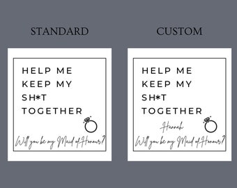 May include: Two white square cards with black text. One reads "HELP ME KEEP MY SH*T TOGETHER" and "Will you be my Maid of Honour?" with a ring graphic. The other card is customized with a name.