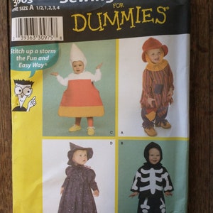 May include: Sewing pattern for toddlers' costumes from Simplicity for Dummies. The pattern includes four costumes: a candy corn, a scarecrow, a witch, and a skeleton. The pattern number is 3603.