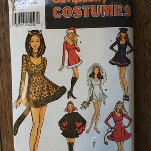 May include: Simplicity Costumes sewing pattern featuring illustrations of six different costume designs. The costumes include a cat, Santa, bride, sailor, devil, and vampire. The pattern is labeled "Betsy Kelly".