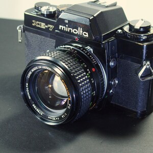 Nice Minolta XE-7 35mm SLR w/ great 1.4 50mm Lens.  Minor age issues It will make good photos.