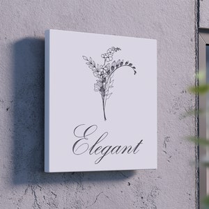 May include: A white sign with a black line drawing of a floral bouquet and the word "Elegant" in cursive script.