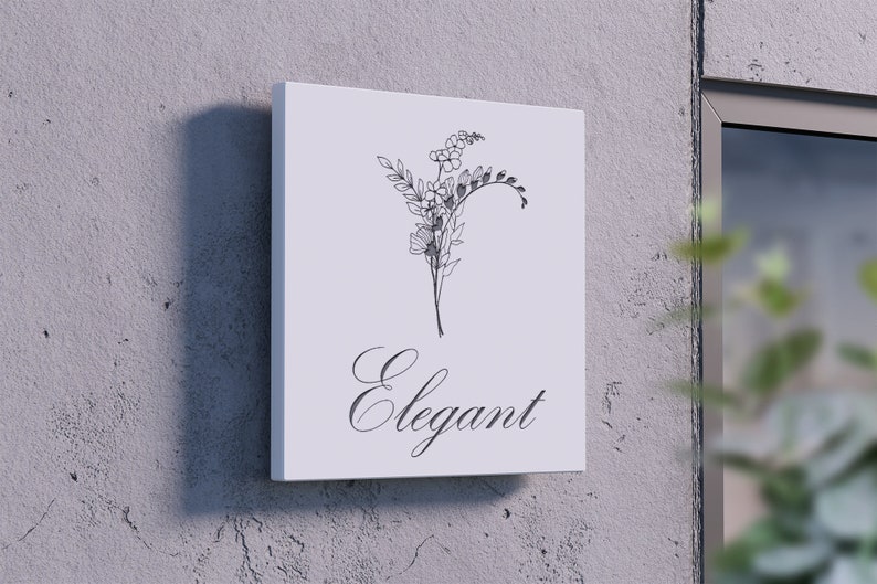 May include: A white sign with a black line drawing of a floral bouquet and the word "Elegant" in cursive script.