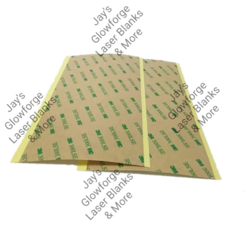 May include: Two rectangular laser blanks with a brown backing and yellow adhesive edges. The backing is printed with "3M 300LSE" and other text. The image also includes the text "Jay's Glowforge Laser Blanks & More."