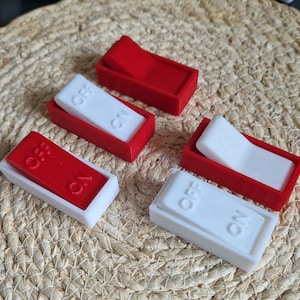 May include: Four toggle switches, two red and two white, with the words "ON" and "OFF" printed on them. The switches are made of plastic and have a rectangular shape.