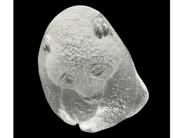 May include: A clear glass sculpture of a panda bear in a sitting position. The sculpture is detailed with a textured surface and the panda's facial features are visible.