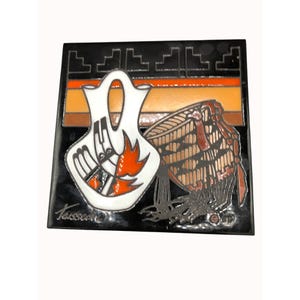 May include: A black ceramic tile with a white and orange design of a Native American pottery jar and a basket. The tile is signed "Tassone" in the bottom left corner.