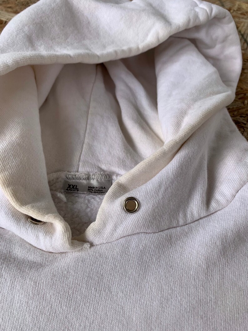 May include: White hooded sweatshirt with a tag that reads "XXL" and "Made in USA 80% Cotton 20% Polyester".