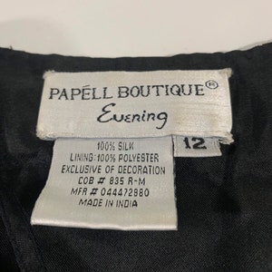 May include: White tag with black text that reads "PAPELL BOUTIQUE&reg; Evening 100% SILK LINING: 100% POLYESTER EXCLUSIVE OF DECORATION COB # 835 R-M MFR # 044472880 MADE IN INDIA" and a black tag with white text that reads "12".