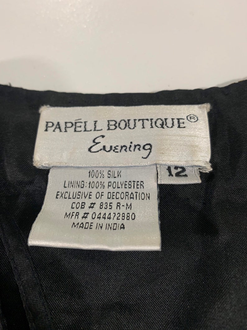 May include: White tag with black text that reads "PAPELL BOUTIQUE&reg; Evening 100% SILK LINING: 100% POLYESTER EXCLUSIVE OF DECORATION COB # 835 R-M MFR # 044472880 MADE IN INDIA" and a black tag with white text that reads "12".