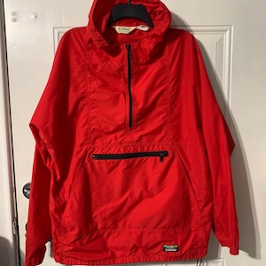May include: A red hooded jacket with a zipper closure and a large pocket on the front. The jacket has a drawstring at the bottom and the L.L.Bean logo is visible on the lower right side.