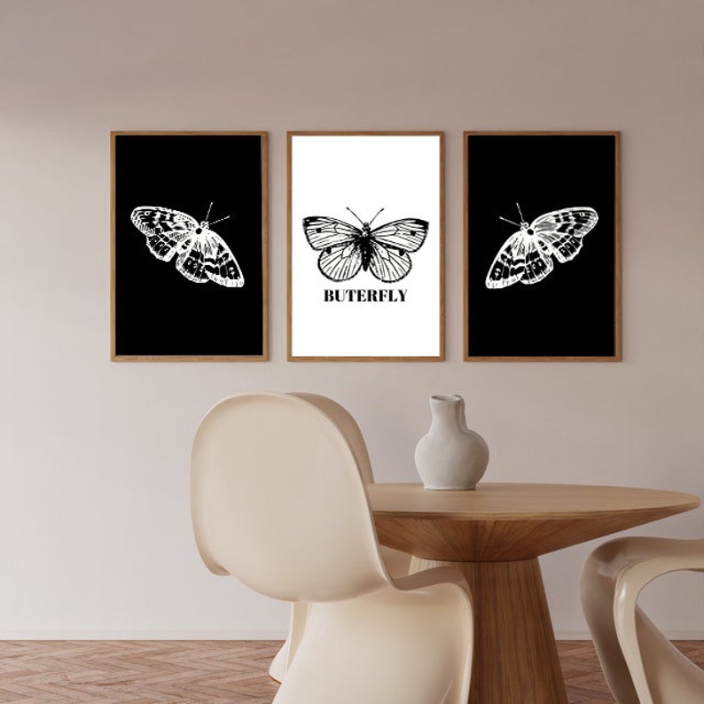 May include: Three framed prints with black and white illustrations of butterflies. The center print has the word "BUTERFLY" printed below the butterfly.