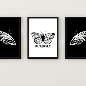 May include: Three black framed prints with white butterfly illustrations. The center print has the word "BUTTERFLY" in black text.