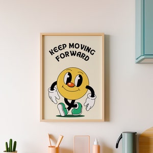 Puede incluir: Una impresión enmarcada con un personaje de dibujos animados amarillo con el texto "Keep Moving Forward" sobre un fondo blanco.