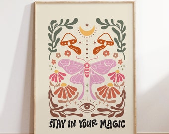 May include: A beige poster with a colorful illustration of a butterfly, mushrooms, flowers, and stars. The text "Stay in your magic" is at the bottom of the poster.