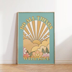 May include: A retro-style poster with a blue background and a yellow sun rising over clouds. The text "Do All Things With Love" is in a yellow arch above the sun.