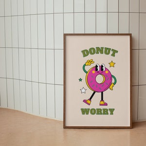 May include: A framed print with a cartoon donut character with the text "DONUT WORRY" in green letters.