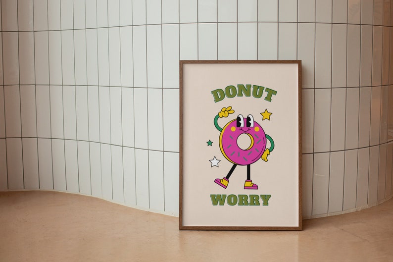 May include: A framed print with a cartoon donut character with the text "DONUT WORRY" in green letters.