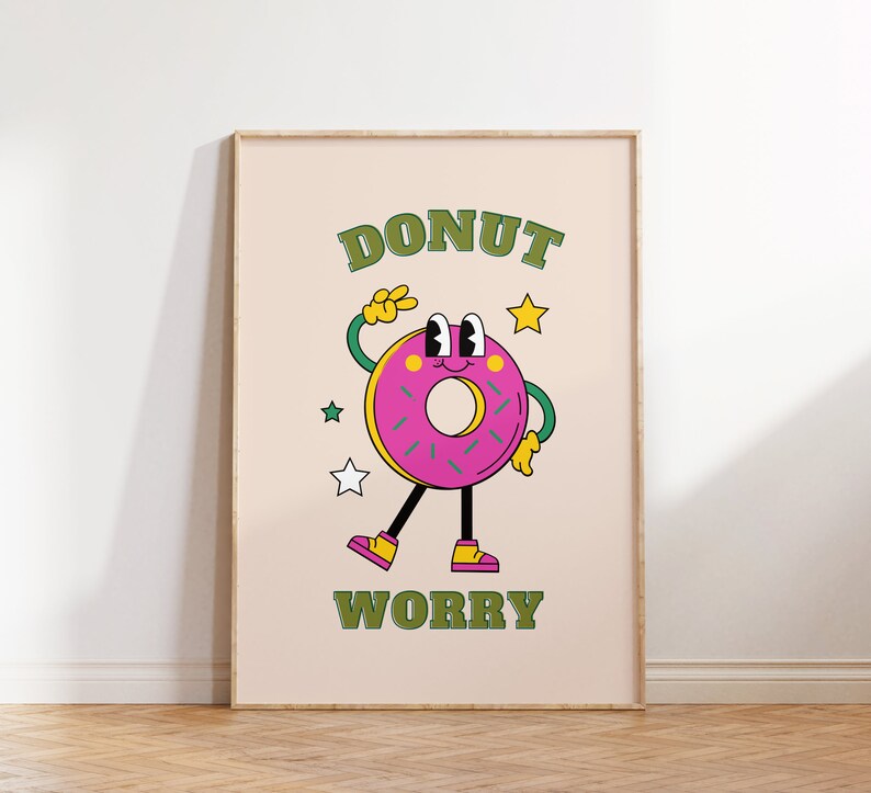 May include: A pink donut with green sprinkles and a smiling face is holding up a peace sign. The donut is wearing yellow shoes and has a green outline. The text "DONUT WORRY" is written in green letters above and below the donut.