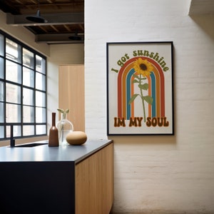 May include: A retro-style poster featuring a sunflower and rainbow design. The text on the poster reads "I got sunshine in my soul."