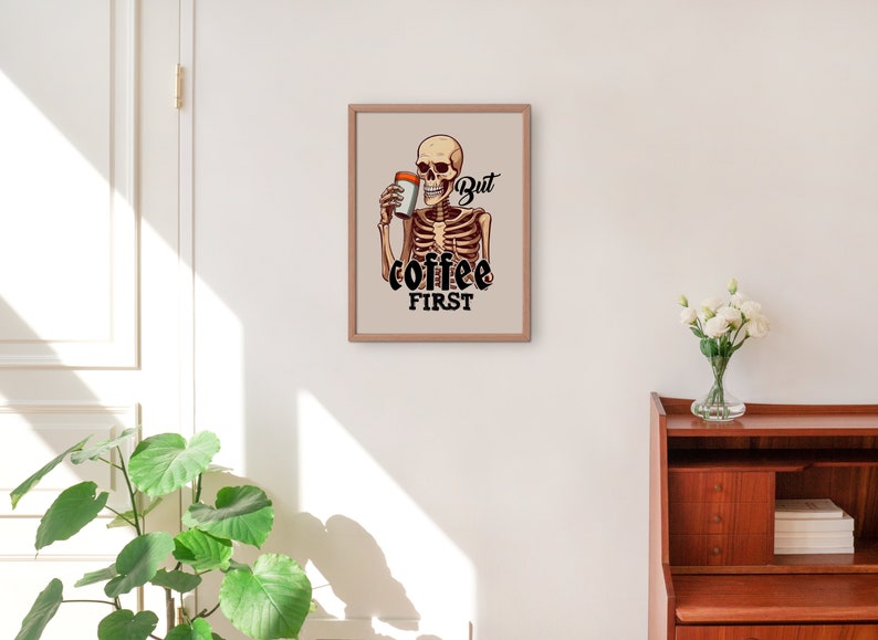 May include: A framed print featuring a cartoon skeleton holding a cup of coffee with the text "But coffee first".