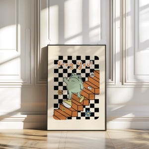 May include: A retro-style illustration of a green frog wearing shoes and walking up a set of orange stairs. The stairs are on a black and white checkered background. The text "Frog You!" is above the frog.