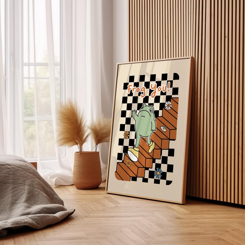 May include: A poster featuring a checkered background with a green frog ascending a set of stairs. The frog is wearing yellow shoes and the text "Frog you!" is written in orange letters.