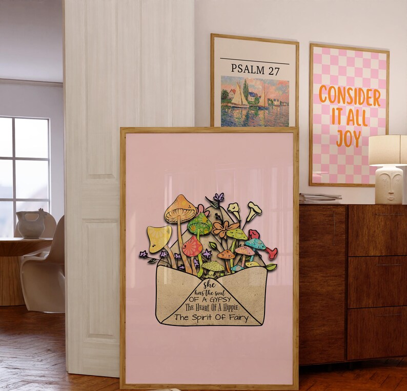 May include: A framed art print featuring a pink background with an illustration of colorful mushrooms and flowers emerging from an envelope. The text on the envelope reads "She has the soul of a Gypsy, The Heart of a Hippie, The Spirit of Fairy."
